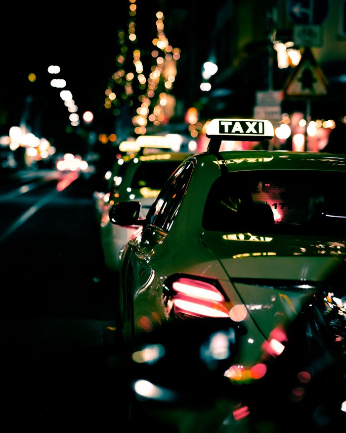 pexels photo 10497156 Night street view of lined up taxis in Düsseldorf, creating a vibrant urban atmosphere.