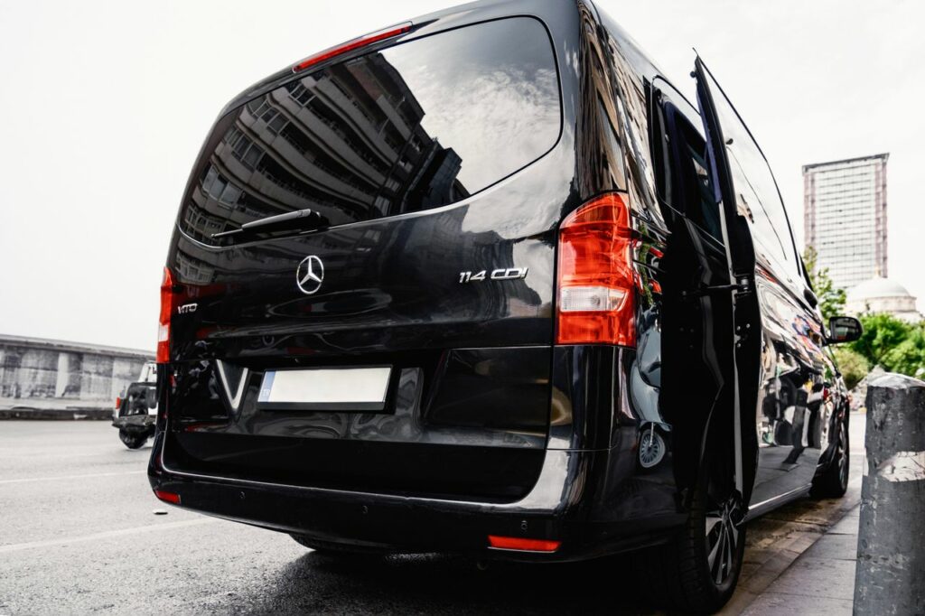 pexels photo 17455630 Rear view of a black luxury van on a city street, showcasing urban lifestyle.