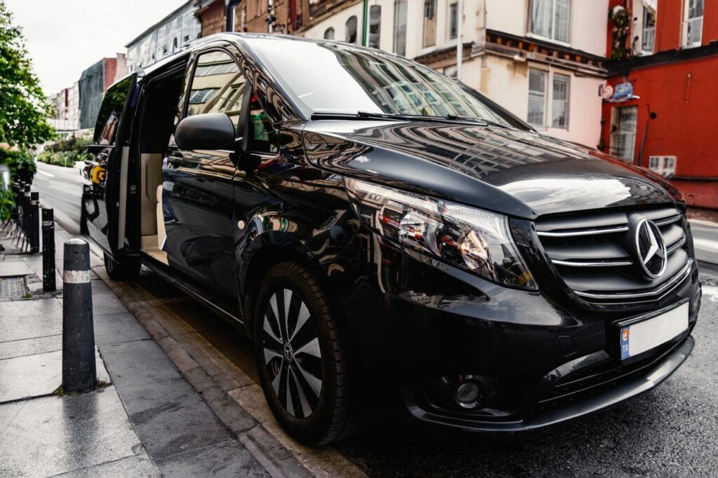 pexels photo 17455633 A stylish black Mercedes-Benz van parked on a bustling city street, showcasing luxury and modern design.