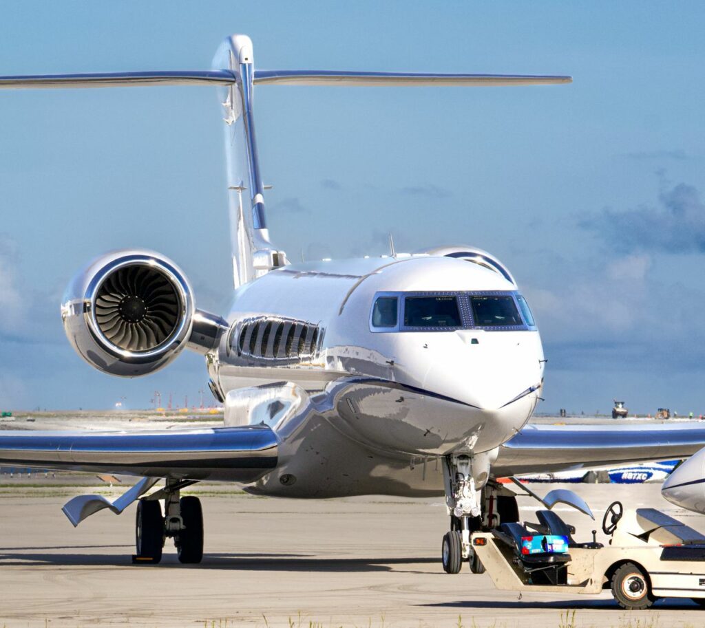 pexels photo 28776071 A sleek private jet parked on the tarmac with supporting ground vehicle under a clear blue sky.